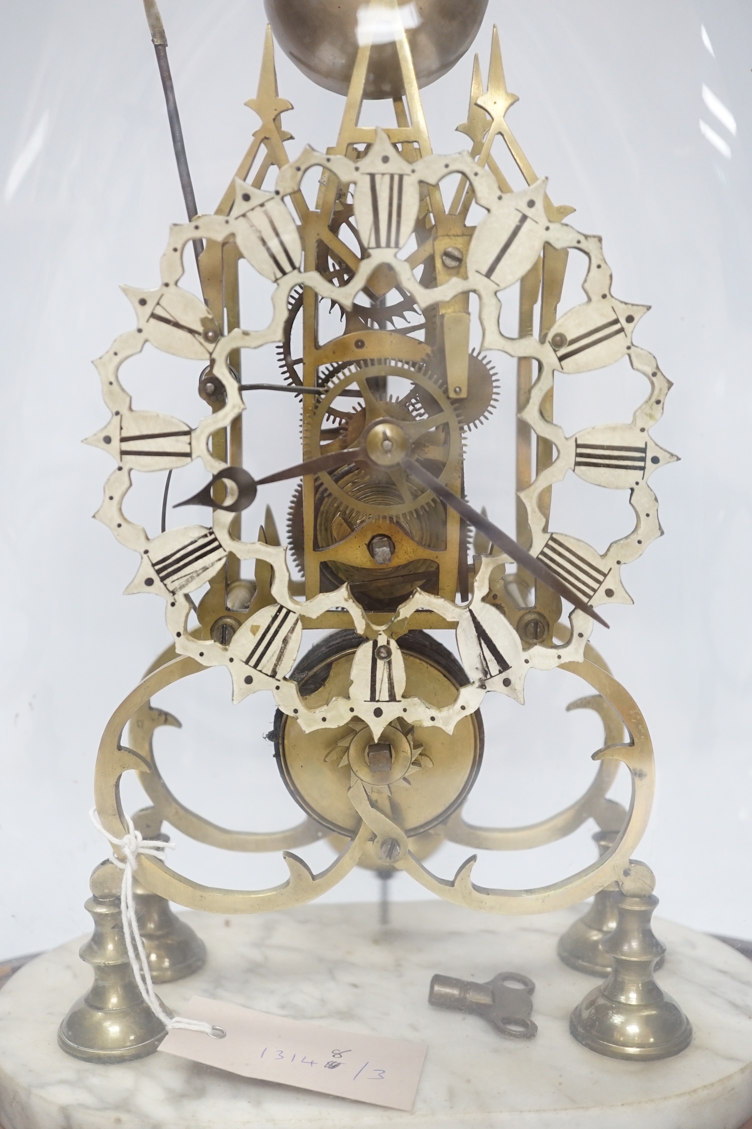 A late 19th century skeleton clock, under glass dome, 44cm high